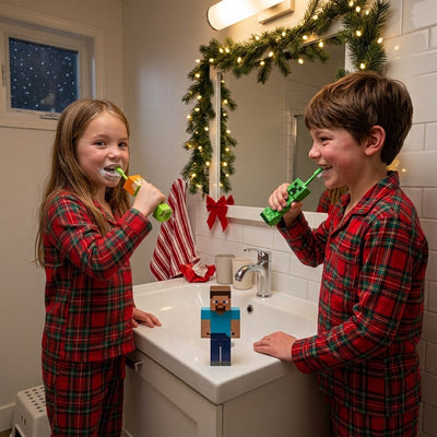 Brother and sister in Christmas pajamas brushing with their own Alex and Creeper Minecraft toothbrushes