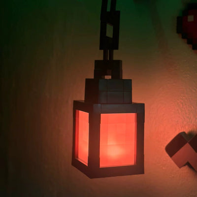 Pixel Lantern hanging from its chain on the wall